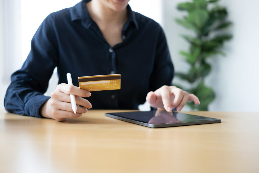 Secure online payment with credit card and digital tablet for financial transactions.