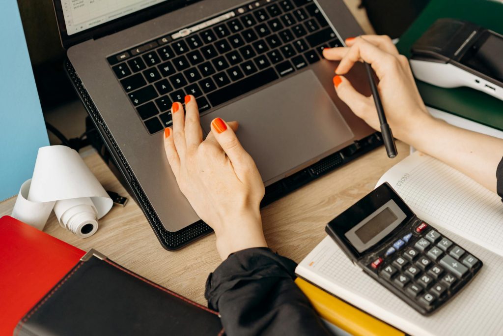 Financial planning and analysis on a laptop for Daybook Financial Group, emphasizing financial services, bookkeeping, and accounting expertise.